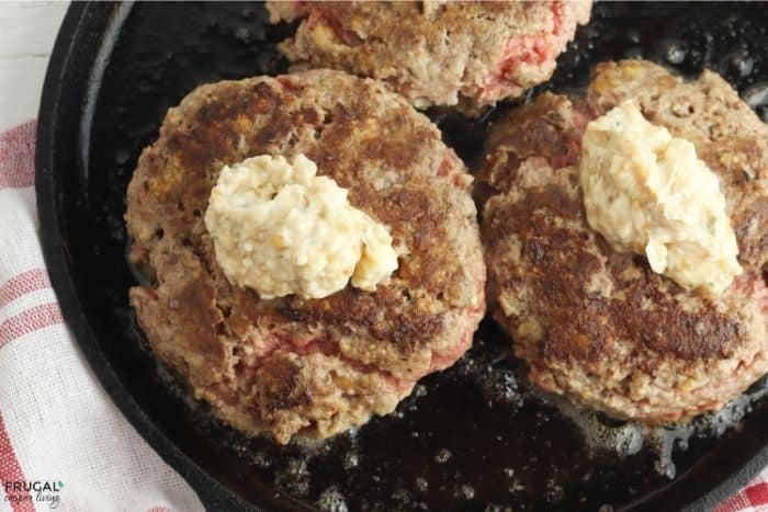 southern hamburger steak on a skillet with garlic butter sauce