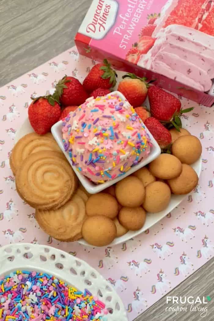 display of strawberry cake mix dip with cookies and unicorn sprinkles