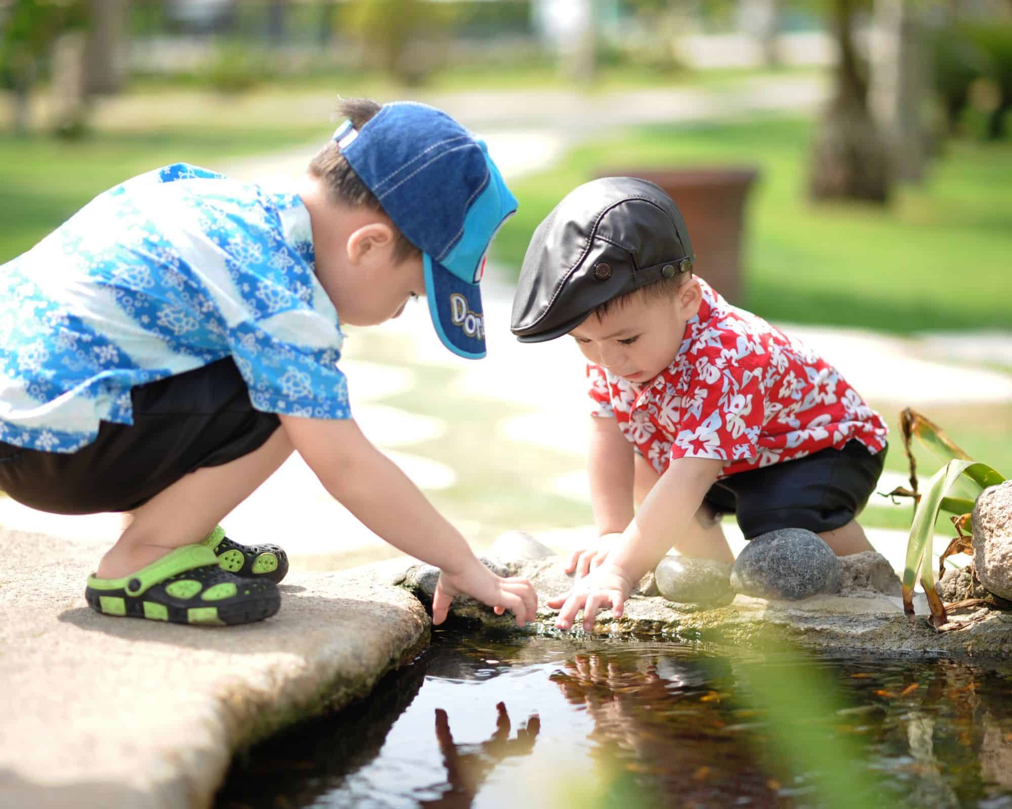 kids exploring a pond