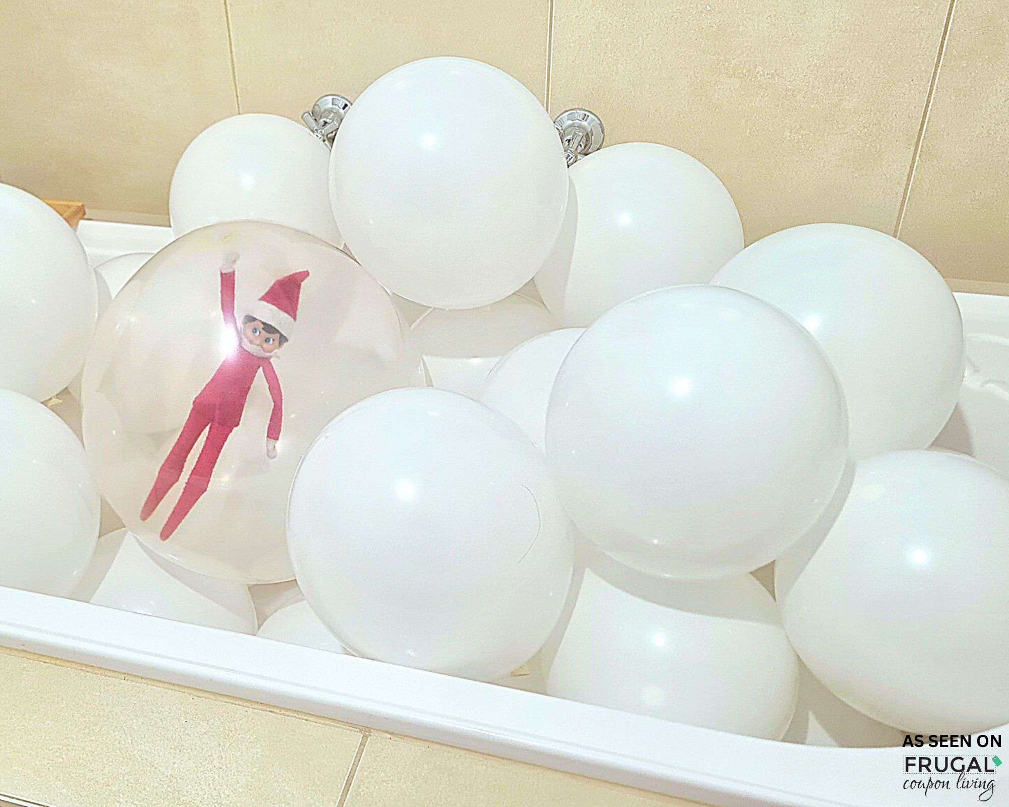 the elf on the shelf trapped in a balloon in a bathtub full of balloons